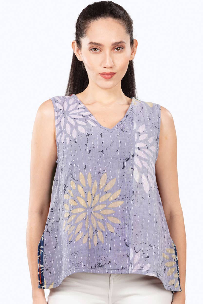 Woman wearing a sleeveless top with a floral pattern on a white background