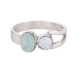 Silver ring with two gemstones on a white background