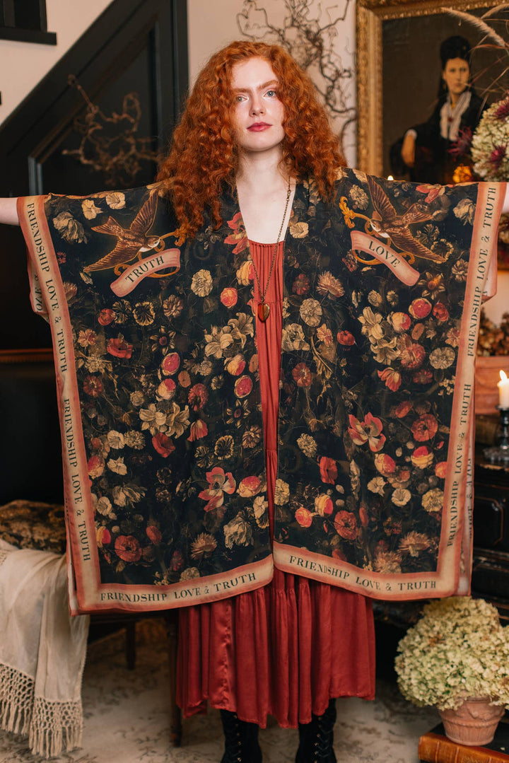 Woman wearing a floral patterned kimono in a vintage interior setting