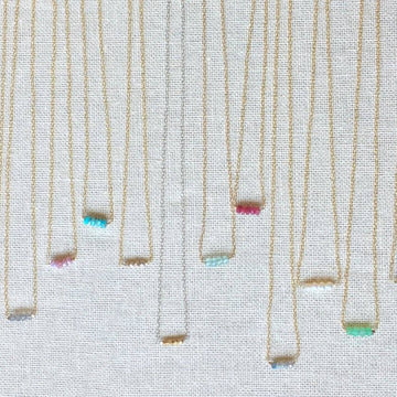 Multicolored necklaces on a textured background