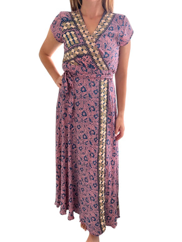 Woman wearing a patterned dress on a white background