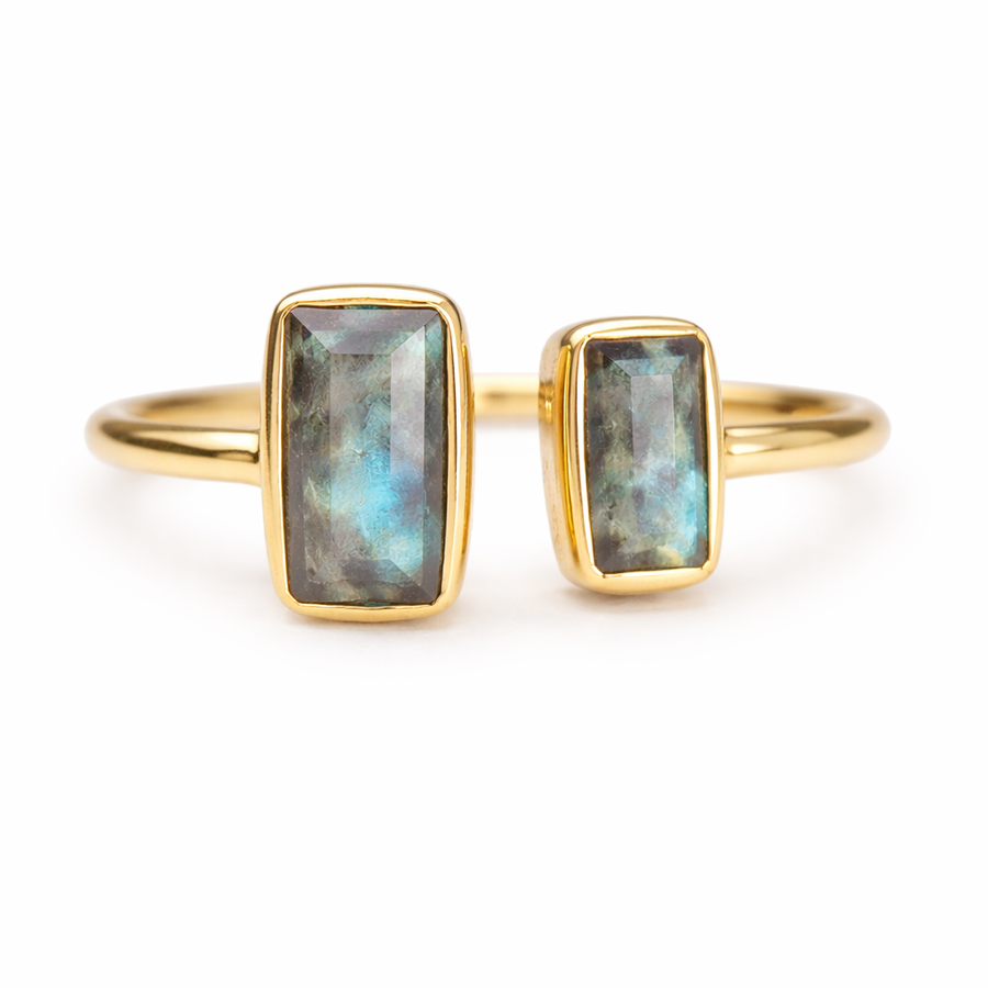 Gold ring with Labradorite stones on a white background
