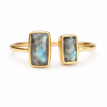 Gold ring with Labradorite stones on a white background