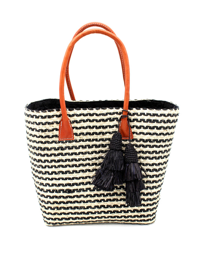 Striped tote bag with orange handles and black tassel on a white background