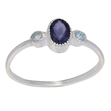 Silver ring with a central purple gemstone flanked by two smaller blue gemstones on a white background