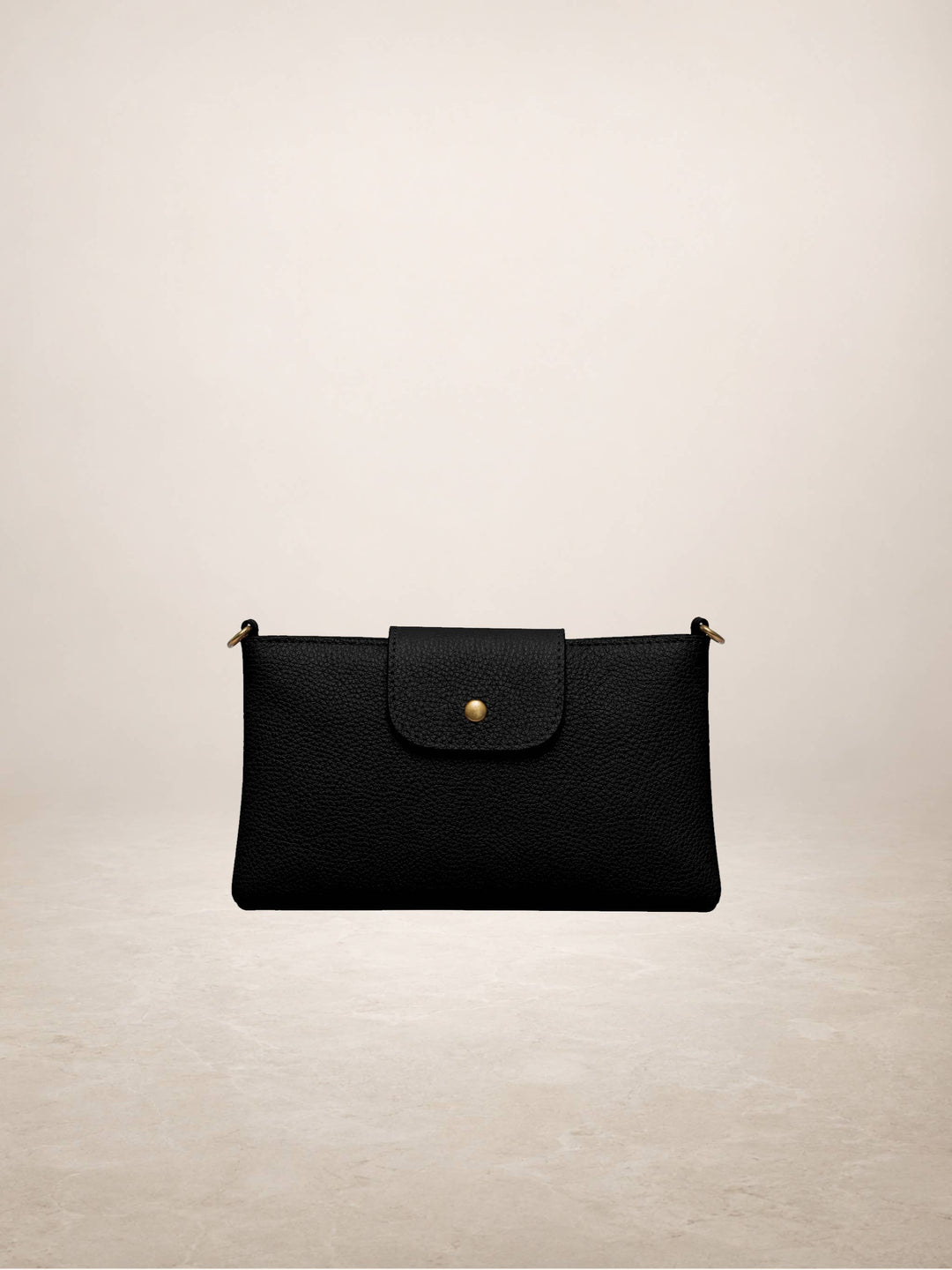 A black textured leather clutch bag with a front flap and a small gold button closure, shown against a neutral beige background.