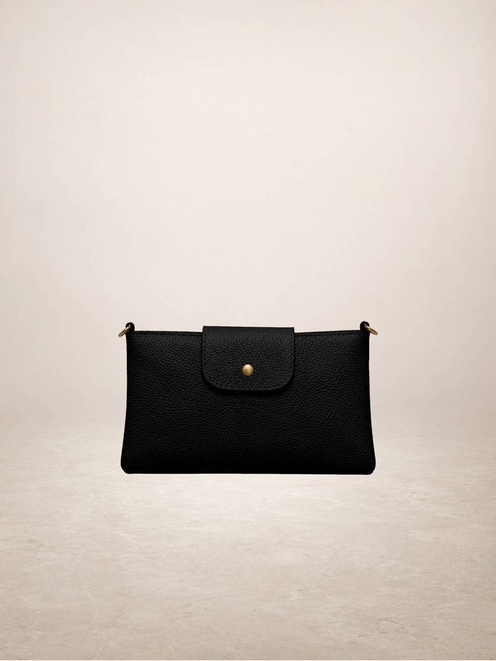 A black textured leather clutch bag with a front flap and a small gold button closure, shown against a neutral beige background.