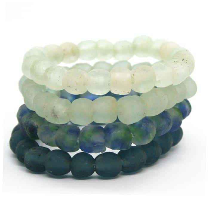 Set of three beaded bracelets in white, blue, and green on a white background