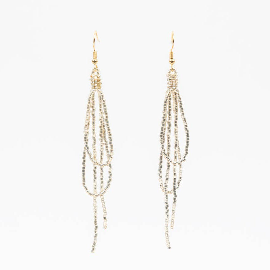 Pair of gold beaded earrings on a white background