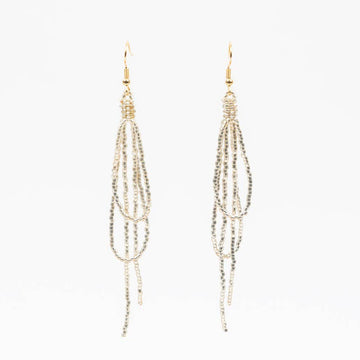 Pair of gold beaded earrings on a white background