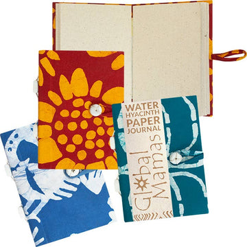 Colorful paper journals with fabric covers on a white background