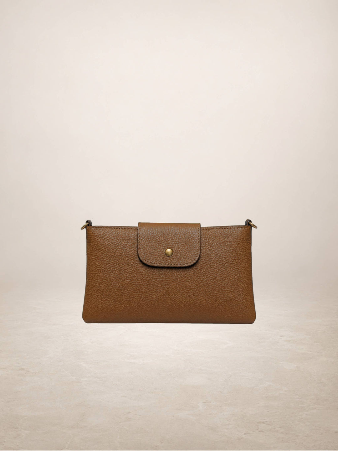 A brown pebbled leather clutch bag with a front flap and a small gold button, shown against a neutral beige background.