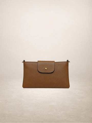 A brown pebbled leather clutch bag with a front flap and a small gold button, shown against a neutral beige background.