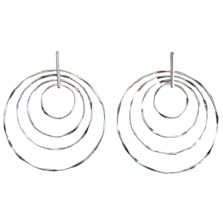 Silver hoop earrings with multiple concentric circles on a white background