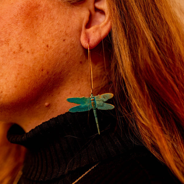 Model wearing Beautiful hand made brass patina dragonfly dangle earrings