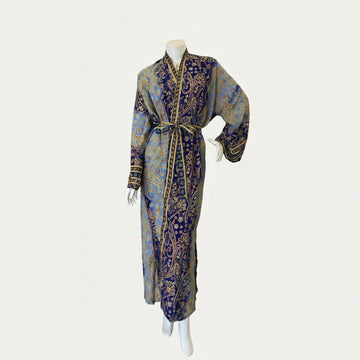 Decorative dress with intricate patterns on a mannequin against a white background