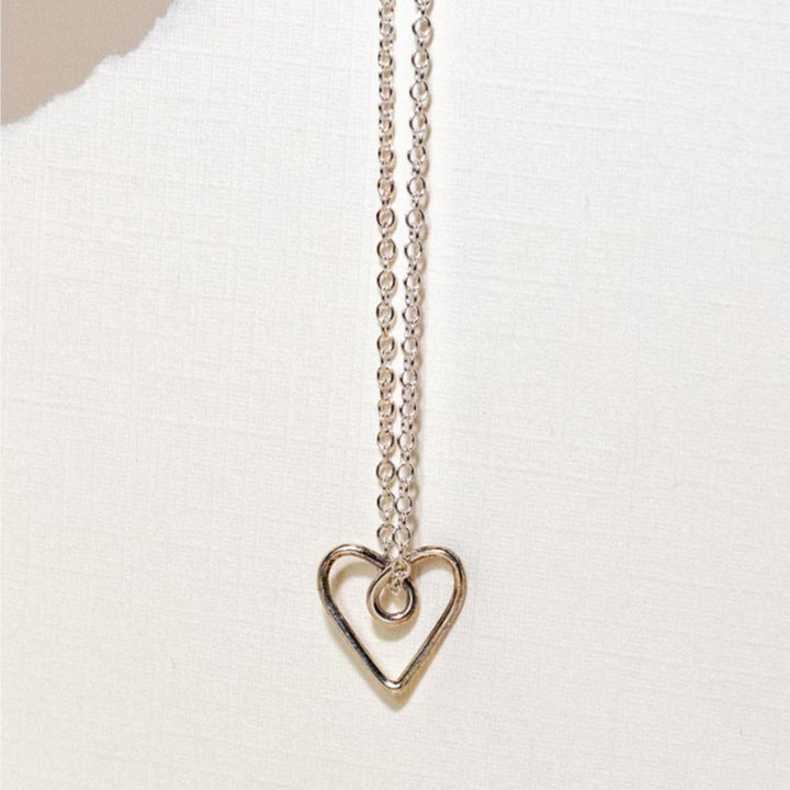 Beautiful and simplistic heart pendant ethically made out of sterling silver, this sterling necklace can act as a standalone piece, or be paired with other accessories. 