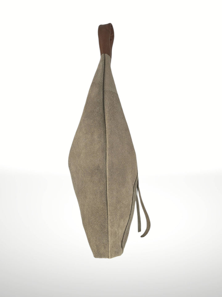 Beige leather bag with a strap on a white background