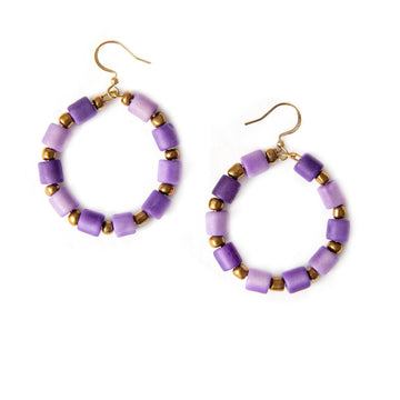 Purple beaded hoop earrings with gold accents on a white background