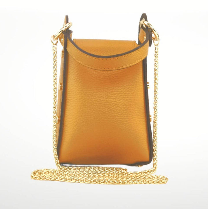 Yellow handbag with a gold chain on a white background