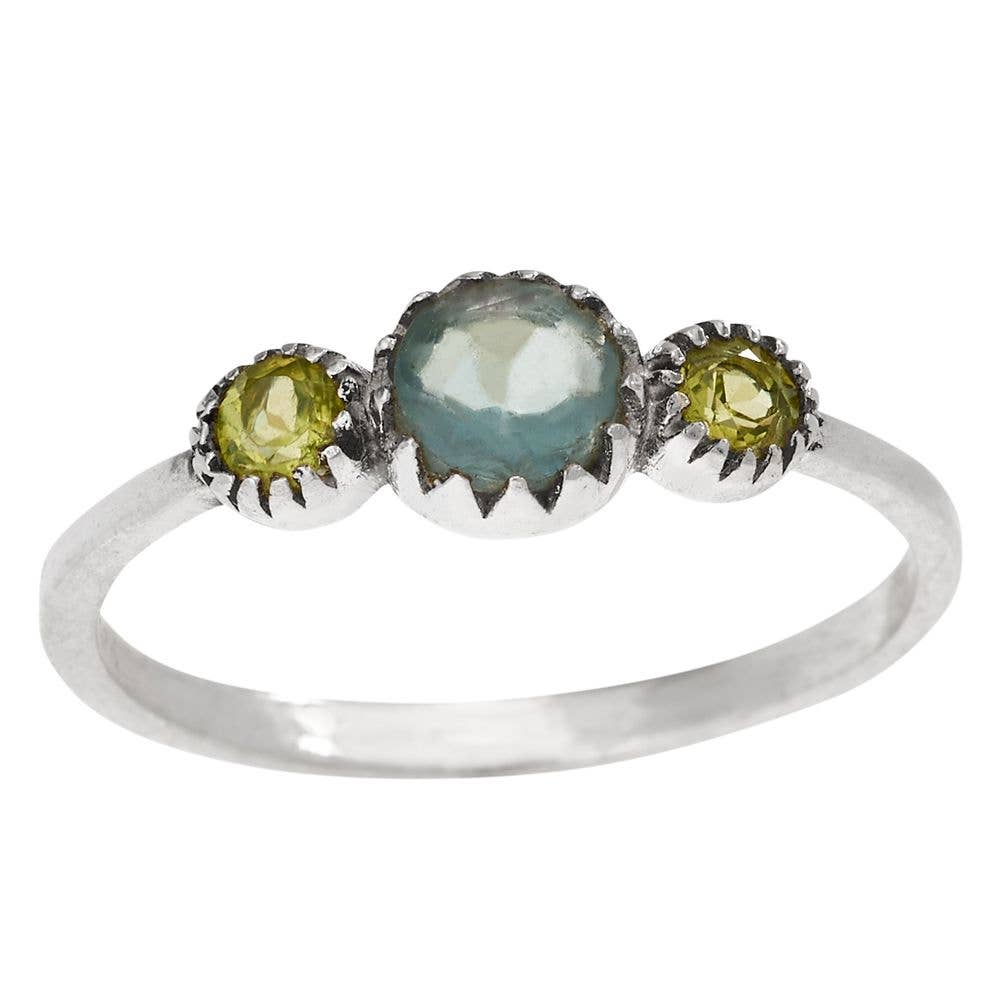 Silver ring with three gemstones on a white background