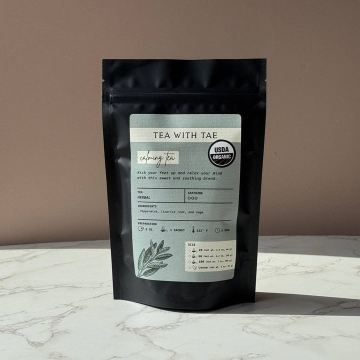 Tea package with label on a marble surface and brown background