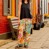 Sohza Sister fairtrade dragonfly pants. Full leg flowy pants with brightly colored floral pattern.