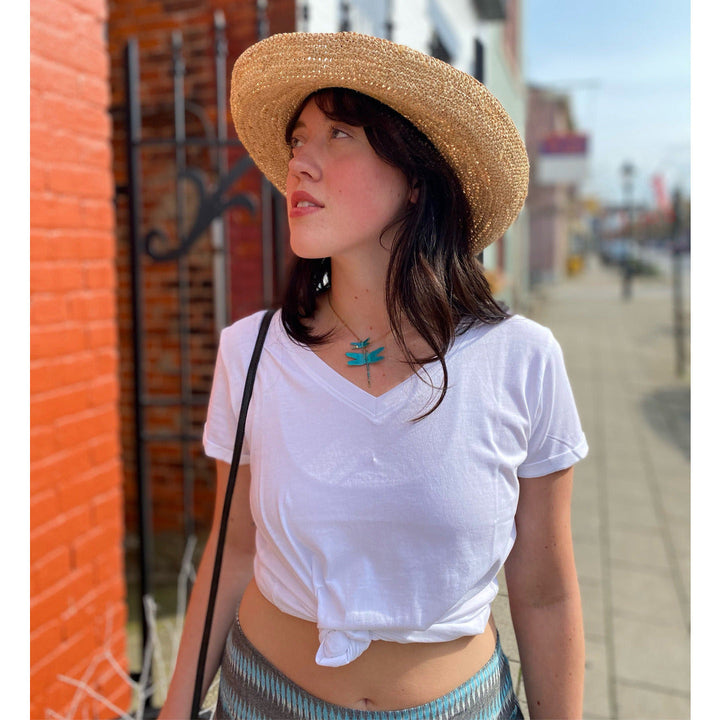 Model wearing Beautiful brass-patina dragonfly necklace with two dragonflies